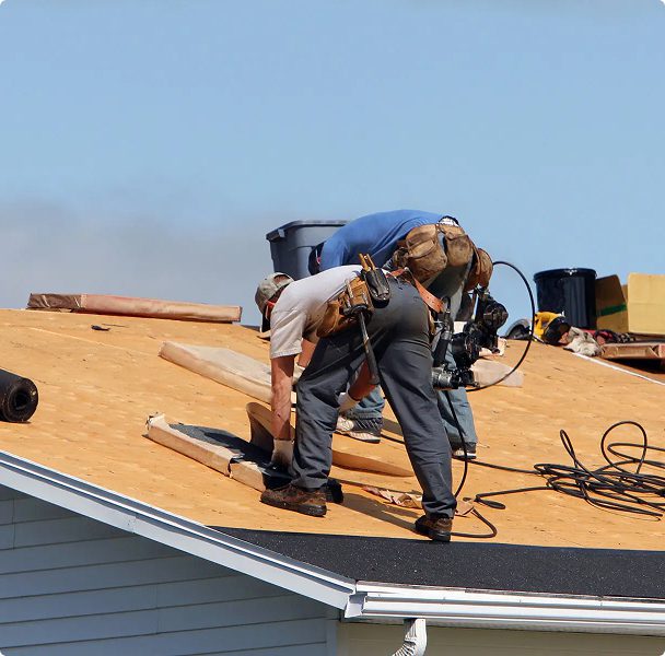 Roofers working on a house roof construction.